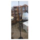 Ornate metal base floor lamp with glass shade