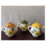 Three ceramic flowered tea pots 4 inches tall can