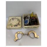 Assortment of keys, keychains, set of cuffs, lock