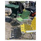 Three folding lawn chairs one with overhead shade