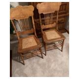 2 oak spindle back chairs with woven cane seats