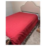 Full-size bed with. fabric-upholstered headboard