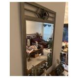 Metal framed wall mirror with decorative rose