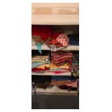 Shelf full of ladies clothes assorted sizes shelf