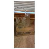 Clear glass basket and swirling flower vase