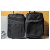Two rolling luggage suitcases