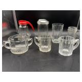 Seven pieces of kitchen glassware.