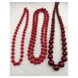 3 different shades of red beaded necklaces
