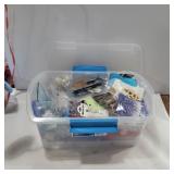 Charms and crafts in container with lid