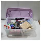 Glitter, paint, brushes in container with lid