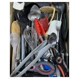 Assorted kitchen utensils spatulas, ladle, tongs,