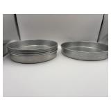 Four 8 1/2 inch aluminum cake pans and one 9 1/2