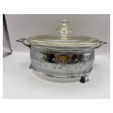 Casserole dish on a decorative metal stand.