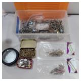 Assorted safety pins in container with lid