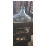 Wine bottle in wooden crate with small amount of