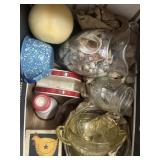 Depression glass, candle, vase of seashells,