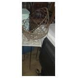 Ornate metal plant stand with handing wire