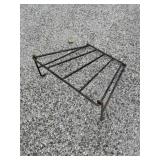 wall-mounted hay feeder or a blanket/tack rail