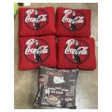4 Coca-Cola seat cushions and a throw pillow