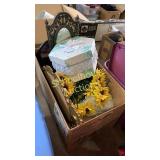 box of plastic flowers and ornate mirrors