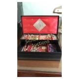 Old jewelry box filled with assorted jewelry