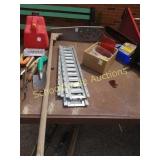 A stick with holes. Metal plate not included