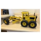 Tonka yellow road grader. Tires marked MR-970