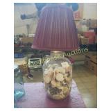 Glass jar lamp full of shells and glow and dark