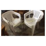 4 white plastic lawn chairs. Some lake sand