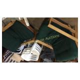 Two wooden green cushioned reclining chairs