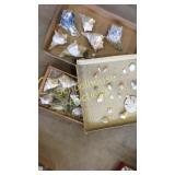 Three little flats of shells and sand dollars