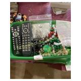 Green storage box of jewelry and remotes