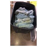 Tall tote of blue jeans and stuffed animals. With