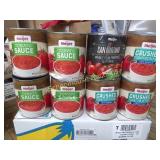 8 cans of assorted tomato products. The cans are