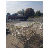 Tall white table with 4 barstools.