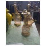 Group of 3  decanters.  Glass is a rose gold