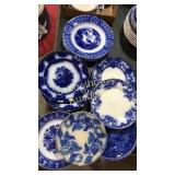 Stack of assorted plates mostly flow blue various