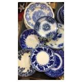 Assorted blue white plates. Some flow blue, wall