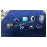 8 assorted blue stone rings. Front L to R: 925,
