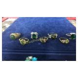 7 assorted green stone rings unmarked