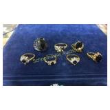 7 assorted black stone rings. Large is Lia