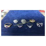 7 assorted rings mostly purples & pinks. Unmarked