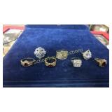 7 assorted rings including reds. 1 marked