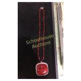 Large coral pendant on beaded necklace