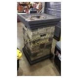 Propane free standing outdoor fireplace. Faux