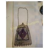 Purple, white, and black purse. Appears to be in