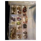 Plastic case full of earrings and misc jewelry