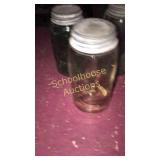 Ball jar with lids one has bubbles one amber