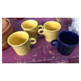 4 fiesta mugs. 3 yellow 1 blue