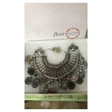 Necklace new in box. Silver colored with "coins"